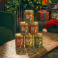 Jars of 'Jalapa Jar' hot sauce stacked on a table with a festive background